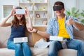 The young family playing games with virtual reality glasses Royalty Free Stock Photo