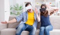 Young family playing games with virtual reality glasses Royalty Free Stock Photo