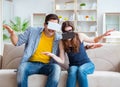 Young family playing games with virtual reality glasses Royalty Free Stock Photo