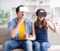 Young family playing games with virtual reality glasses Royalty Free Stock Photo