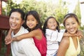 Young Family Playing In Garden Together