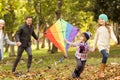 Young family playing with a kite Royalty Free Stock Photo