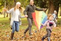 Young family playing with a kite Royalty Free Stock Photo