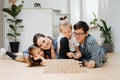 Young family playing together, building toy wall from wooden blocks Royalty Free Stock Photo