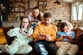 Young family playing video games together in the living room on a gaming console Royalty Free Stock Photo