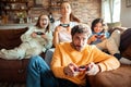 Young family playing video games together in the living room on a gaming console Royalty Free Stock Photo