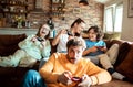 Young family playing video games together in the living room on a gaming console Royalty Free Stock Photo