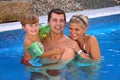 Young family in the pool Royalty Free Stock Photo