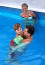 Young family in the pool Royalty Free Stock Photo