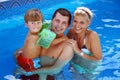 Young family in the pool Royalty Free Stock Photo