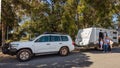 A Young Family proudly standing outside of their caravan and 4WD in front of a Park Royalty Free Stock Photo