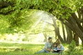 Young family reading the Bible in nature