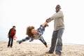 Young Family Relaxing On Beach Camping Holiday Royalty Free Stock Photo