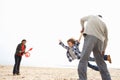 Young Family Relaxing On Beach Camping Holiday Royalty Free Stock Photo