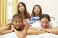 Young Family Relaxing In Bedroom Royalty Free Stock Photo