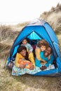 Young Family Relaxing Inside Tent On Holiday Royalty Free Stock Photo