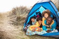 Young Family Relaxing Inside Tent On Holiday Royalty Free Stock Photo