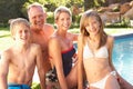 Young Family Relaxing By Pool In Garden