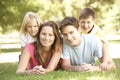 Young Family Relaxing Together In Park Royalty Free Stock Photo