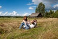 Young family resting in a field Royalty Free Stock Photo