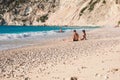 Young family rests on the Myrtos beach, Kefalonia island, Greece during summer sea vacation. Royalty Free Stock Photo