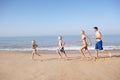 Young family running on beach Royalty Free Stock Photo