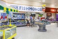 Young family shopping at the fishmongers counter in Morrisons supermarket store.