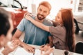 Young Family Are Signing A Contract To Buy A Car. Royalty Free Stock Photo