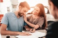 Young Family Are Signing A Contract To Buy A Car. Royalty Free Stock Photo