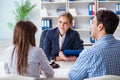 The young family signing marriage documents at laywers office Royalty Free Stock Photo