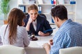 The young family signing marriage documents at laywers office Royalty Free Stock Photo