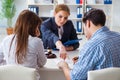 The young family signing marriage documents at laywers office Royalty Free Stock Photo