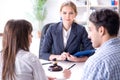 The young family signing marriage documents at laywers office Royalty Free Stock Photo