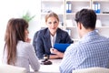 The young family signing marriage documents at laywers office Royalty Free Stock Photo