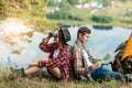 Young family sitting back to back on the grass Royalty Free Stock Photo