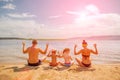 A young family is sitting in a contemplative stance