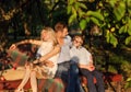 Young family sitting on the garden bench Royalty Free Stock Photo