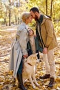 Young family spend autumn weekends outdoors, walking together in forest Royalty Free Stock Photo