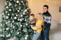 Young family spend time at home in Christmas time. Happy Mom, dad and son enjoyng love hugs, holidays people Royalty Free Stock Photo