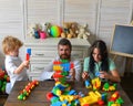 Young family spends time in playroom. Parents and son Royalty Free Stock Photo