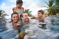 Young family in swimming pool spending good time Royalty Free Stock Photo