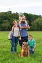 Young family with their pet dog, golden retriever Royalty Free Stock Photo