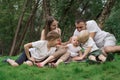 Young family with three children outdoors. Big happy family resting in nature Royalty Free Stock Photo