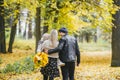 Young family of three having fun in autumn park. View from the back Royalty Free Stock Photo