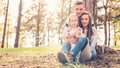 Young family of three having fun in a park enjoying their time together. Real people, authenticity concept