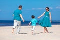 Young family of three having fun tropical beach Royalty Free Stock Photo