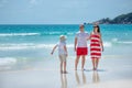 Young family of three having fun tropical beach Royalty Free Stock Photo