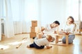 Family together at living room of new apartment assembling furniture, pile of moving boxes on background Royalty Free Stock Photo