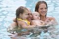 Young family together in swimming pool Royalty Free Stock Photo