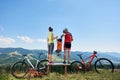 Young modern family tourists bikers, mom, dad and child resting on bikes Royalty Free Stock Photo